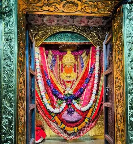 Jeen Mata in her decorated sanctum behind carved silver doors
