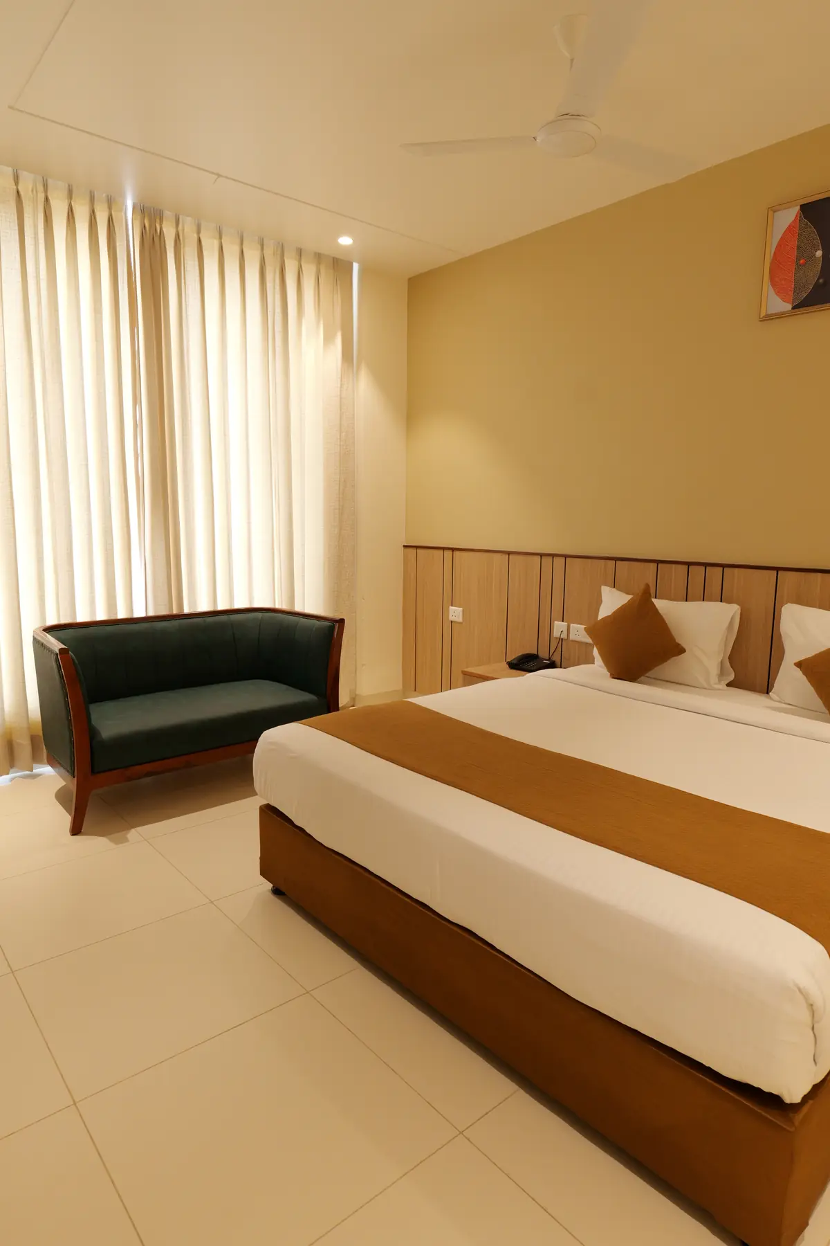 Guest room with king bed and a loveseat by the window
